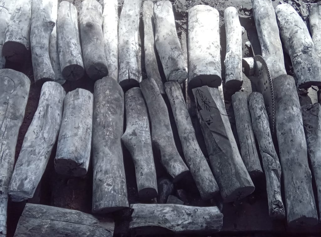 Hardwood charcoal logs stacked, ready for wholesale packaging